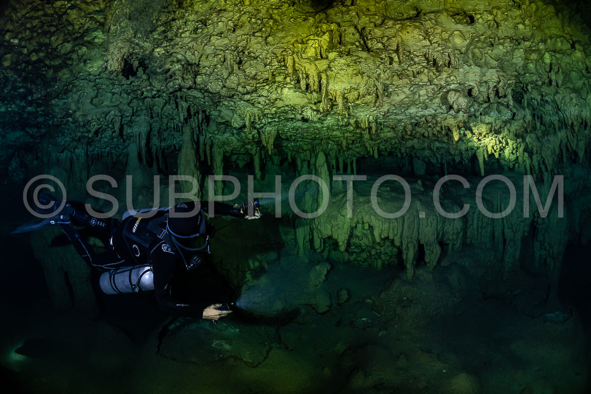 cave diver instructor leading a group of divers in a mexican cenote underwater