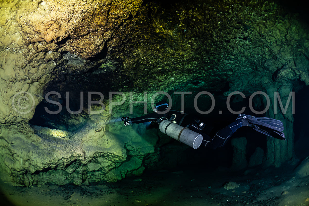 cave diver instructor leading a group of divers in a mexican cenote underwater