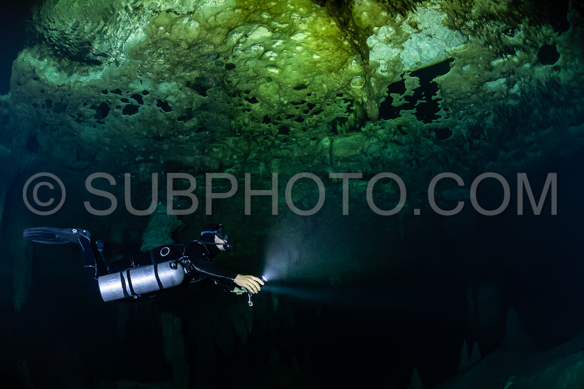 cave diver instructor leading a group of divers in a mexican cenote underwater
