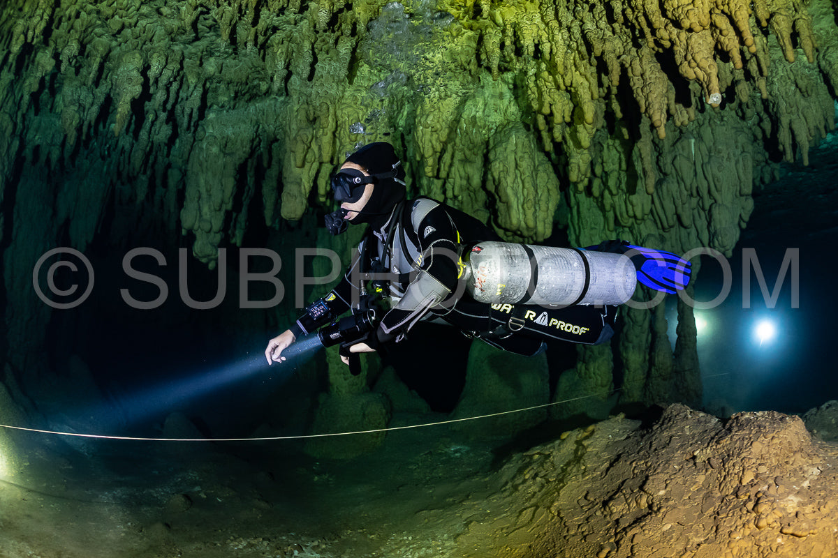 cave diver instructor leading a group of divers in a mexican cenote underwater