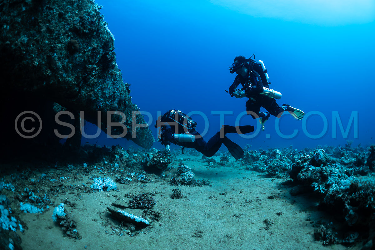 Two divers are exploring a wreck the Red Sea. They are using rebreathers- which allow them to stay underwater for longer periods of time.