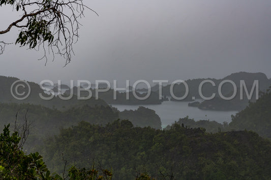 East Misool- group of small island in shallow blue lagoon water under the rain- Raja Ampat- West Papua- Indonesia