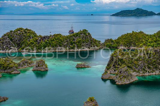Waigeo- Kri- Mushroom Island- group of small islands in shallow blue lagoon water- Raja Ampat- West Papua- Indonesia