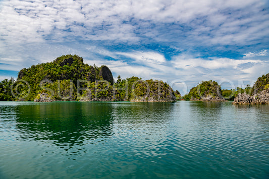 Waigeo- Kri- Mushroom Island- group of small islands in shallow blue lagoon water- Raja Ampat- West Papua- Indonesia