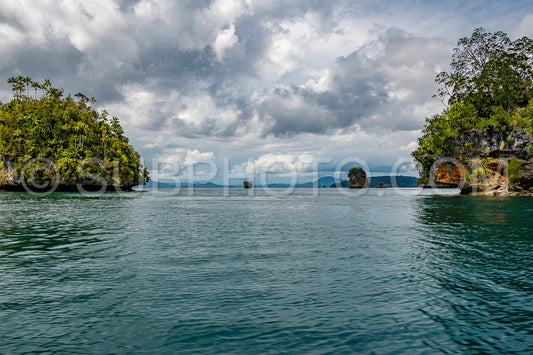 Waigeo- Kri- Mushroom Island- group of small islands in shallow blue lagoon water- Raja Ampat- West Papua- Indonesia