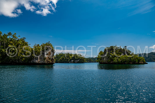 Waigeo- Kri- Mushroom Island- group of small islands in shallow blue lagoon water- Raja Ampat- West Papua- Indonesia