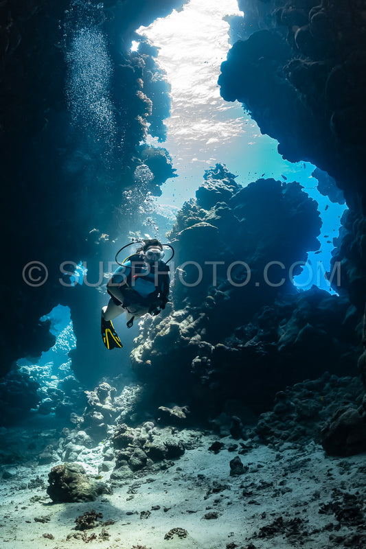 woman diver visiting underwater cave in the Red Sea- egypt- Shaab Claude