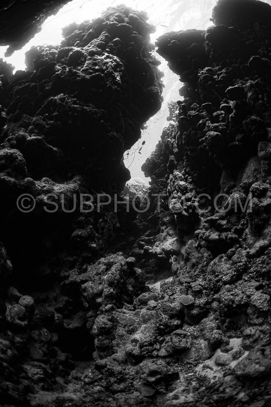 typical underwater cave in a red sea reef in black and white