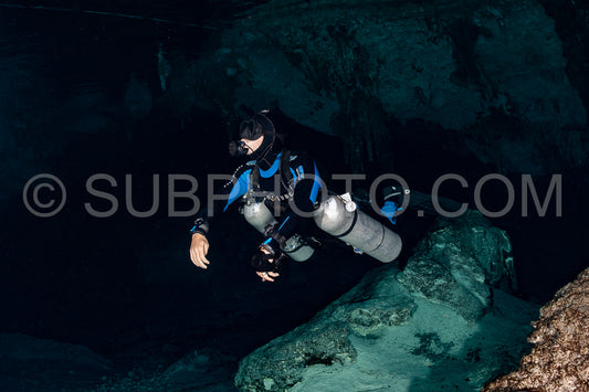 cave diver instructor leading a group of divers in a mexican cenote underwater