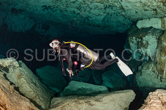 cave diver instructor leading a group of divers in a mexican cenote underwater