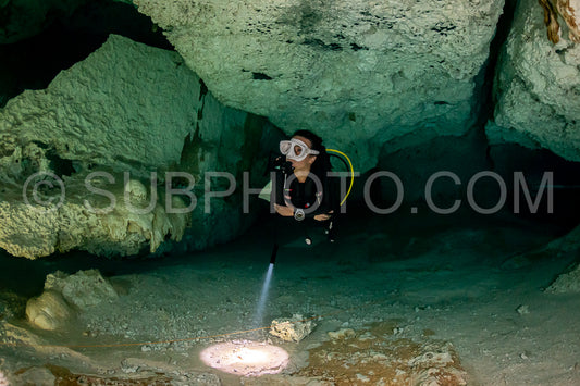 cave diver instructor leading a group of divers in a mexican cenote underwater