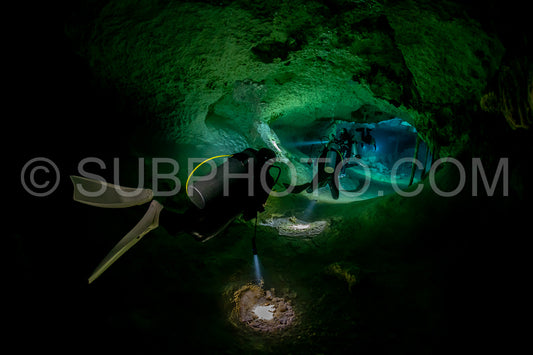 cave diver instructor leading a group of divers in a mexican cenote underwater