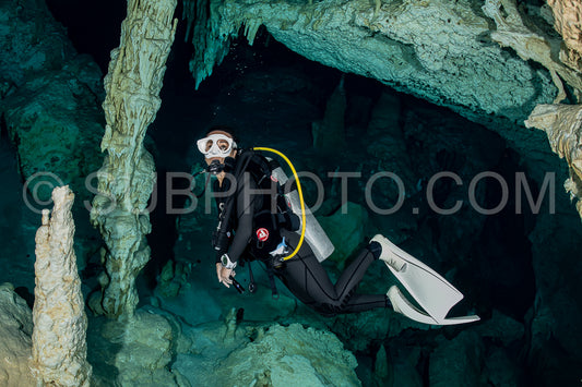 cave diver instructor leading a group of divers in a mexican cenote underwater