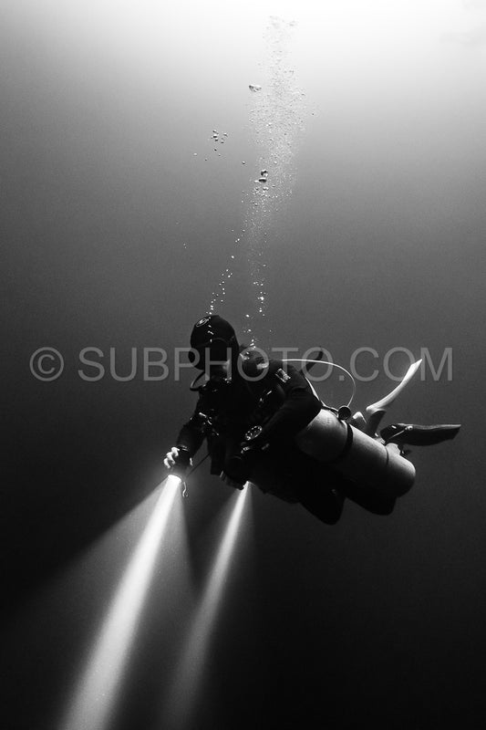 cave diver instructor leading a group of divers in a mexican cenote underwater