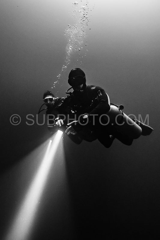 cave diver instructor leading a group of divers in a mexican cenote underwater