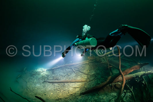 cave diver instructor leading a group of divers in a mexican cenote underwater