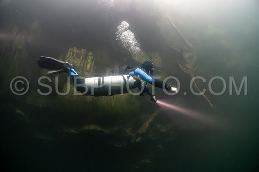 cave diver instructor leading a group of divers in a mexican cenote underwater