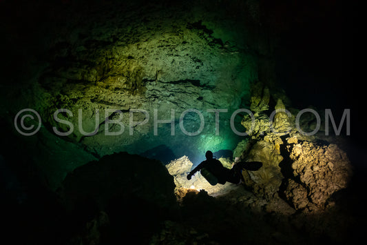 cave diver instructor leading a group of divers in a mexican cenote underwater