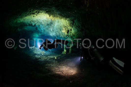 cave diver instructor leading a group of divers in a mexican cenote underwater