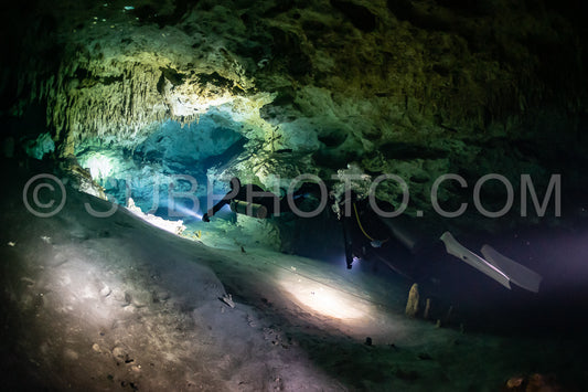 cave diver instructor leading a group of divers in a mexican cenote underwater
