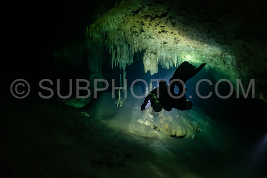 cave diver instructor leading a group of divers in a mexican cenote underwater
