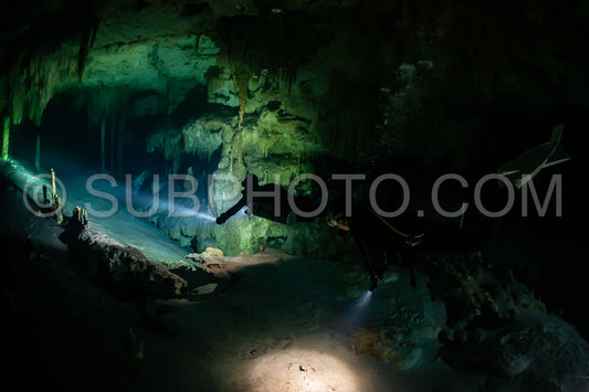 cave diver instructor leading a group of divers in a mexican cenote underwater