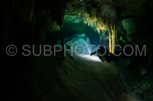 cave diver instructor leading a group of divers in a mexican cenote underwater