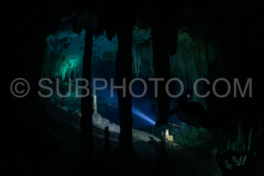 cave diver instructor leading a group of divers in a mexican cenote underwater