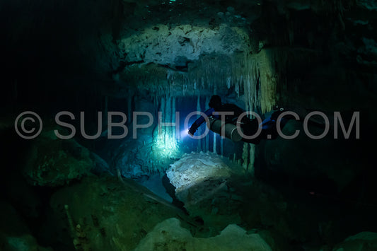 cave diver instructor leading a group of divers in a mexican cenote underwater
