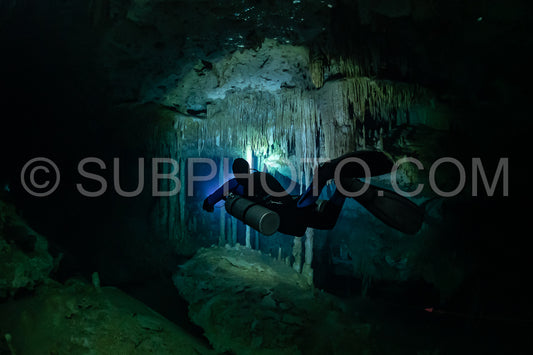 cave diver instructor leading a group of divers in a mexican cenote underwater