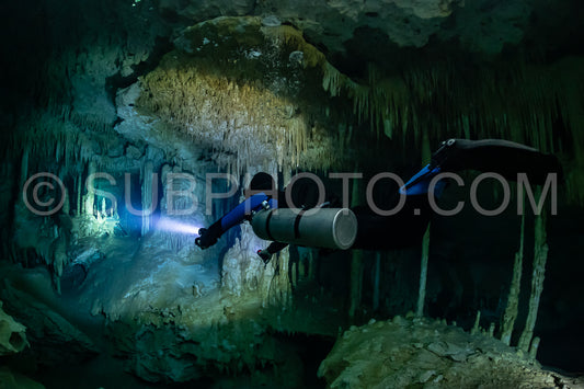 cave diver instructor leading a group of divers in a mexican cenote underwater