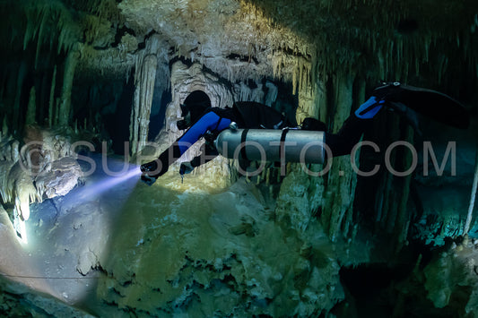 cave diver instructor leading a group of divers in a mexican cenote underwater
