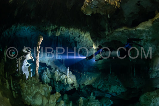 cave diver instructor leading a group of divers in a mexican cenote underwater