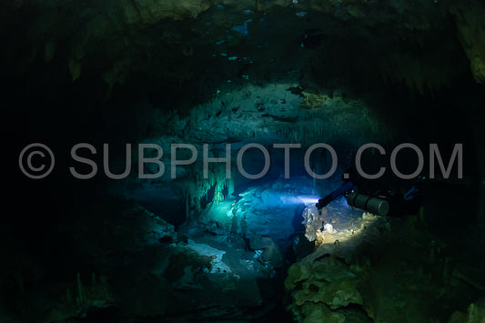 cave diver instructor leading a group of divers in a mexican cenote underwater