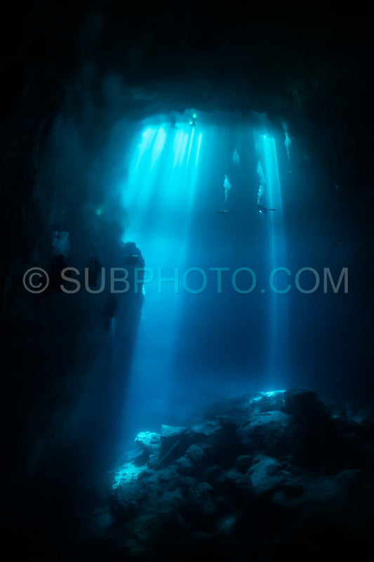 cave diver instructor leading a group of divers in a mexican cenote underwater