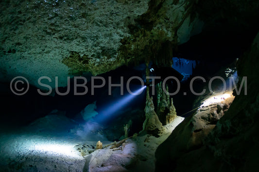 cave diver instructor leading a group of divers in a mexican cenote underwater