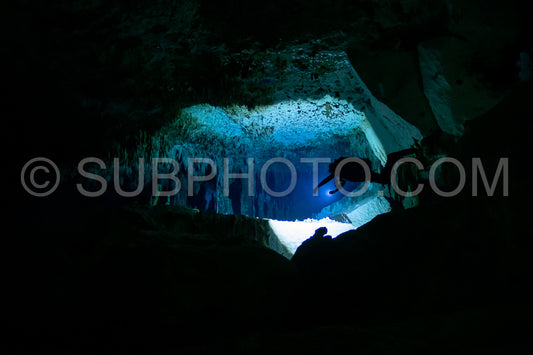 cave diver instructor leading a group of divers in a mexican cenote underwater