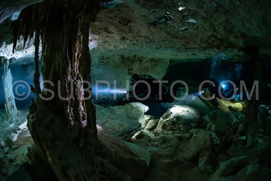 cave diver instructor leading a group of divers in a mexican cenote underwater