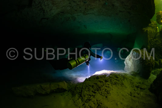 cave diver instructor leading a group of divers in a mexican cenote underwater
