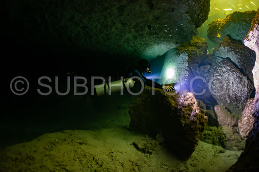 cave diver instructor leading a group of divers in a mexican cenote underwater