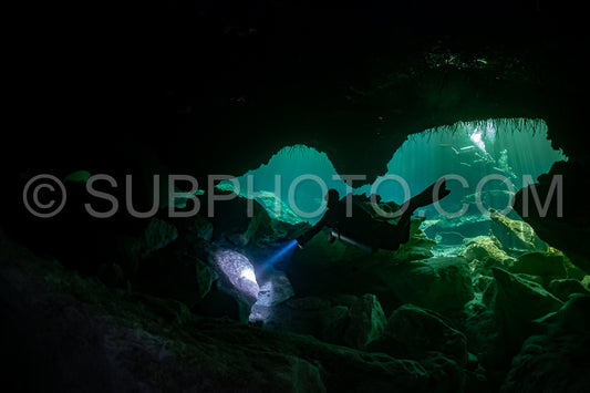 cave diver instructor leading a group of divers in a mexican cenote underwater