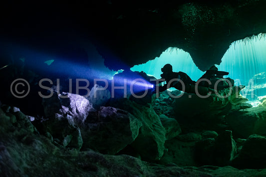 cave diver instructor leading a group of divers in a mexican cenote underwater