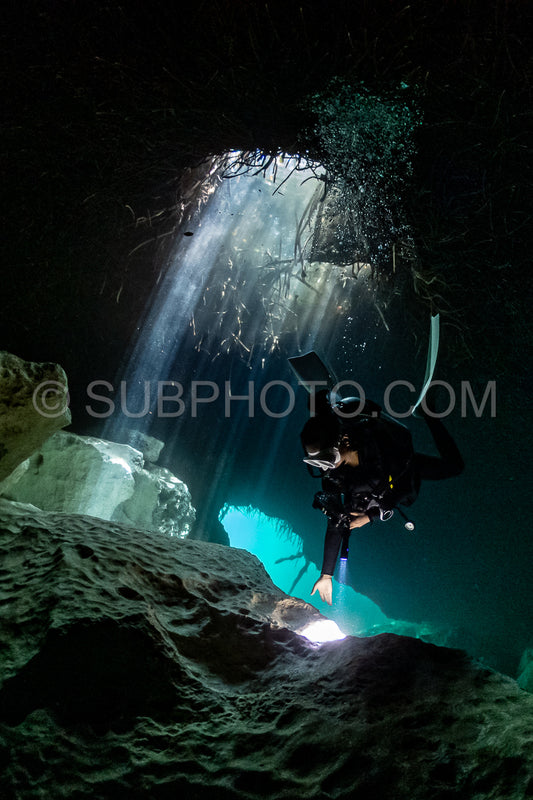 cave diver instructor leading a group of divers in a mexican cenote underwater