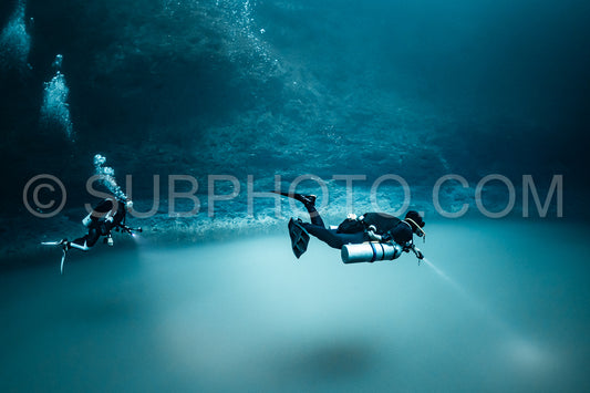 cave diver instructor leading a group of divers in a mexican cenote underwater