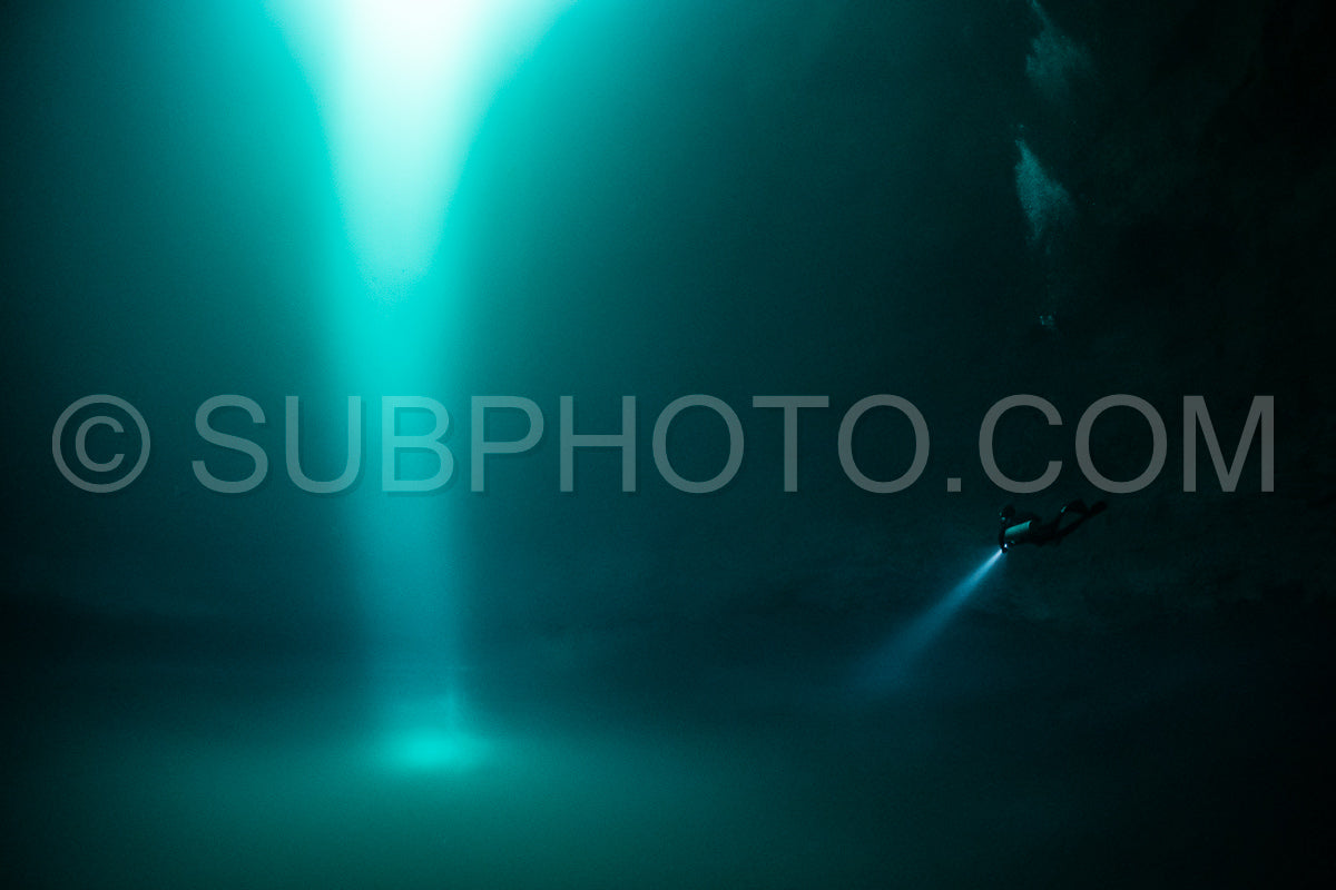 cave diver instructor leading a group of divers in a mexican cenote underwater