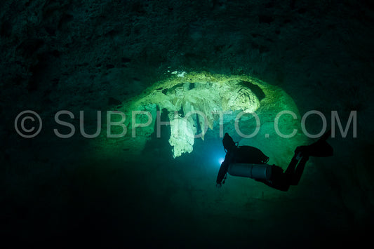 cave diver instructor leading a group of divers in a mexican cenote underwater