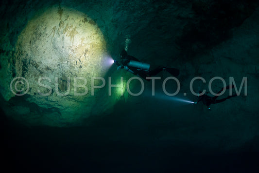 cave diver instructor leading a group of divers in a mexican cenote underwater