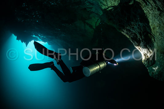cave diver instructor leading a group of divers in a mexican cenote underwater