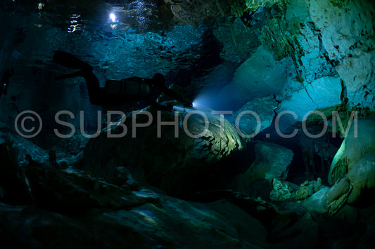 cave diver instructor leading a group of divers in a mexican cenote underwater