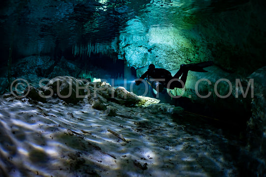 cave diver instructor leading a group of divers in a mexican cenote underwater